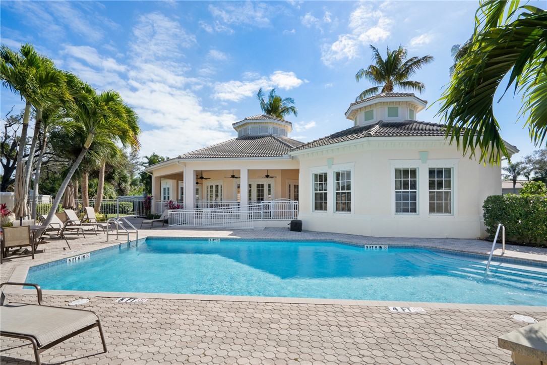 1286 Riverside Place Vero Beach, FL 32963 - Photo 34 of 36 a front view of a house with a yard and potted plants