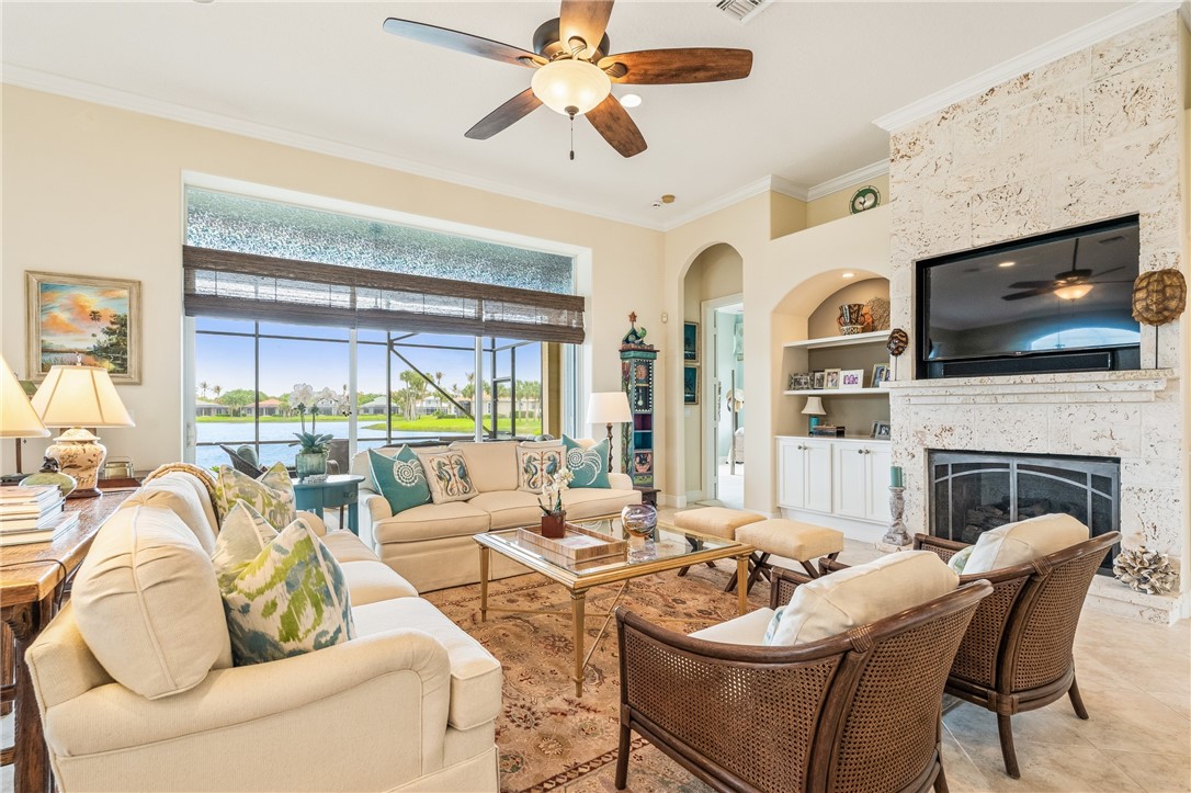 1286 Riverside Place Vero Beach, FL 32963 - Photo 10 of 36 a living room with furniture a fireplace and a flat screen tv