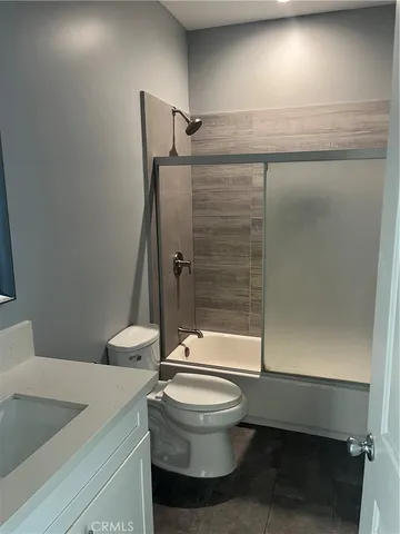 a bathroom with a toilet a sink and shower