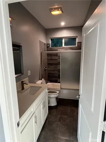 a bathroom with a sink a toilet and mirror