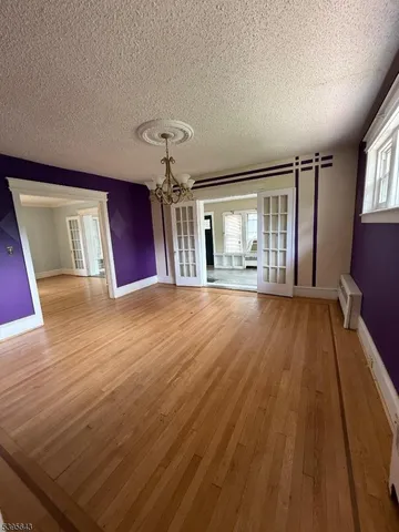 a view of an empty room and wooden floor