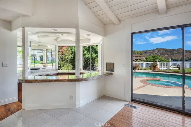 a kitchen with a large window sink and cabinets