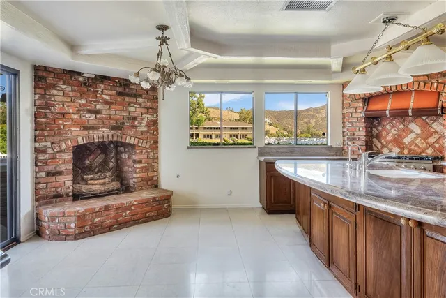 a kitchen with stainless steel appliances granite countertop a sink and a stove