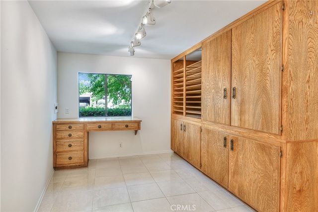 a view of hallway with wooden floor and chandelier