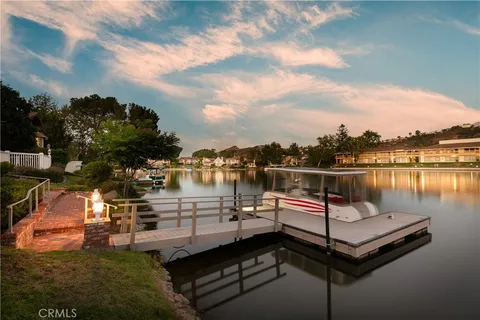 an aerial view of lake and residential houses with outdoor space