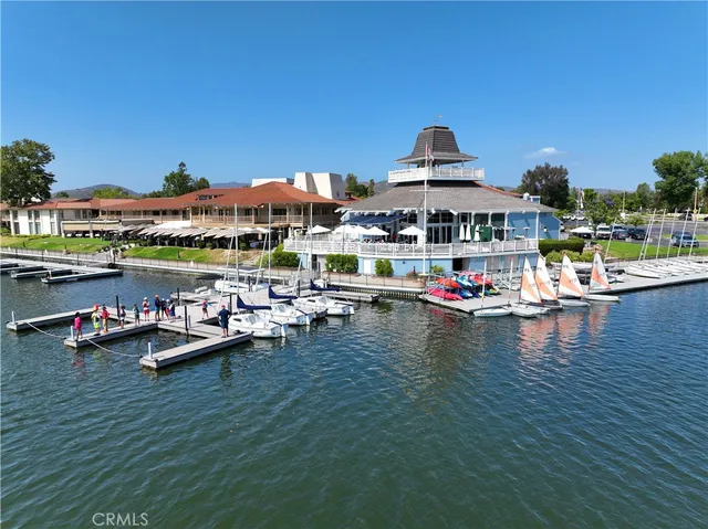 an aerial view of lake and residential houses with outdoor space