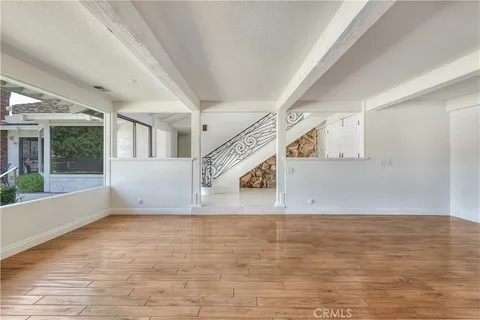 a view of an entryway with wooden floor