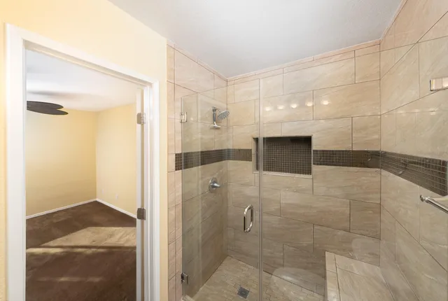 a bathroom with a shower and a mirror