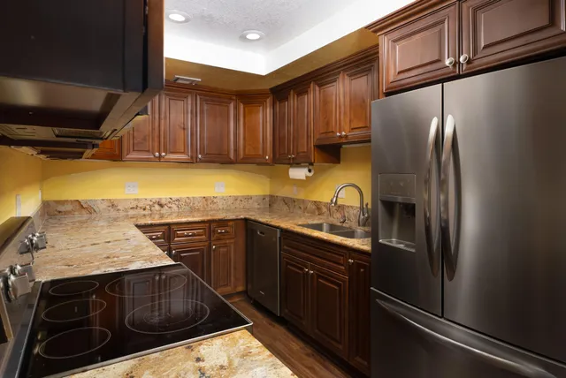 a kitchen with a sink stove and refrigerator