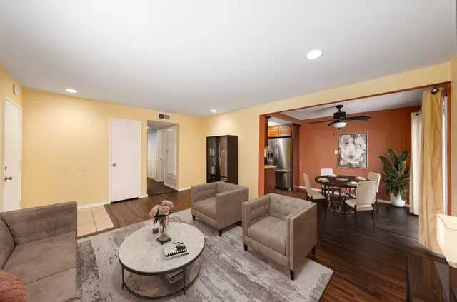 a living room with furniture and wooden floor