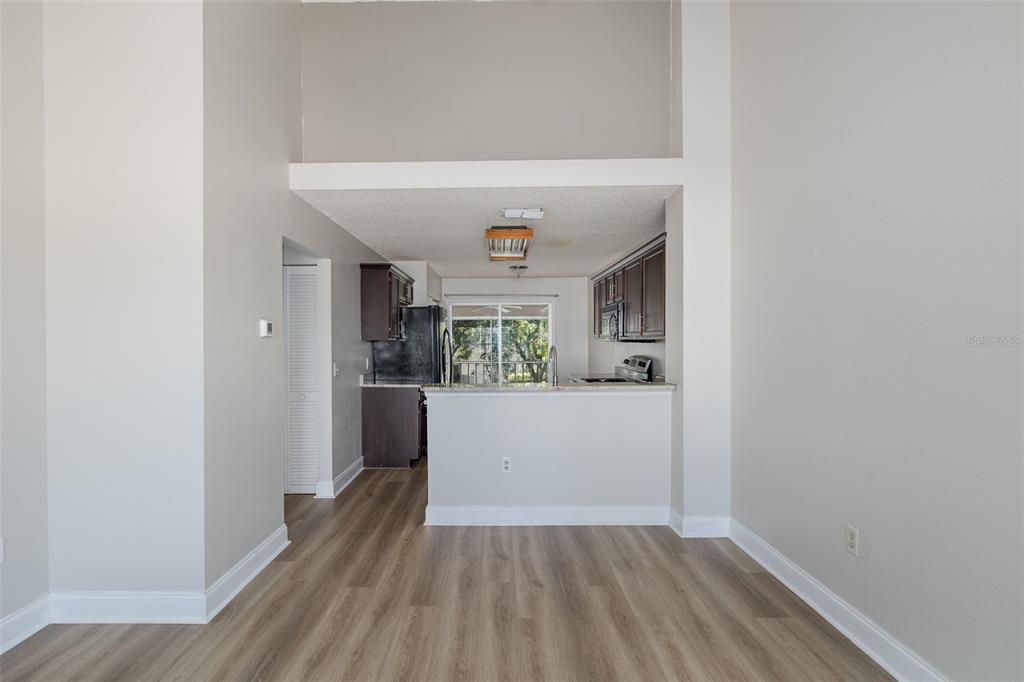 7900 Hardwick Drive, Unit 827 New Port Richey, FL 34653 - Photo 7 of 27 a view of a hallway and a kitchen with wooden floor