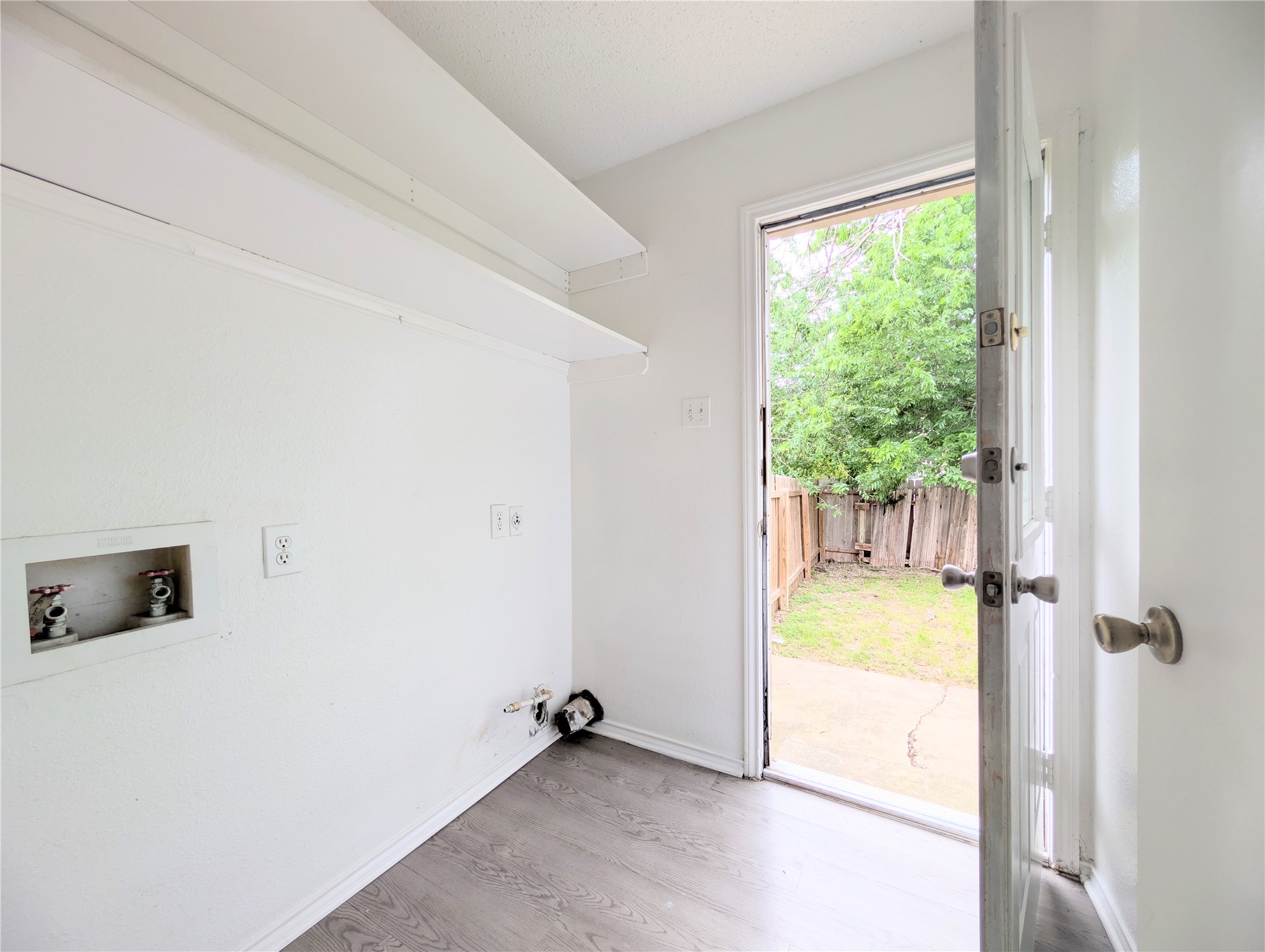 2018 Redwing Way Round Rock, TX 78664 - Photo 12 of 27 Interior utility area featuring wood-finish flooring and white walls