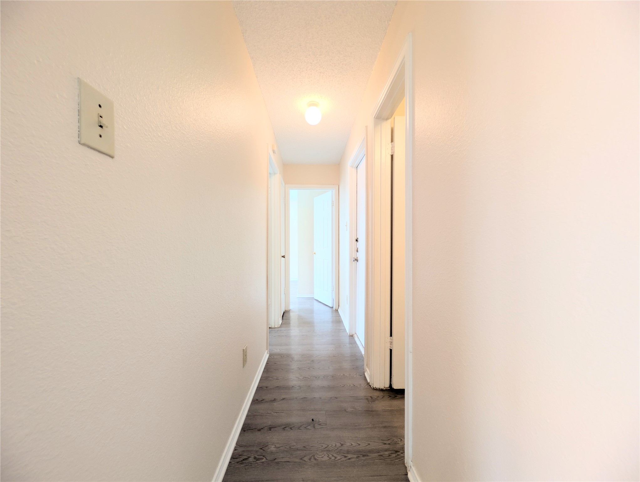 2018 Redwing Way Round Rock, TX 78664 - Photo 13 of 27 Hallway featuring wood-finish flooring, light-toned walls, recessed lighting, and white trim