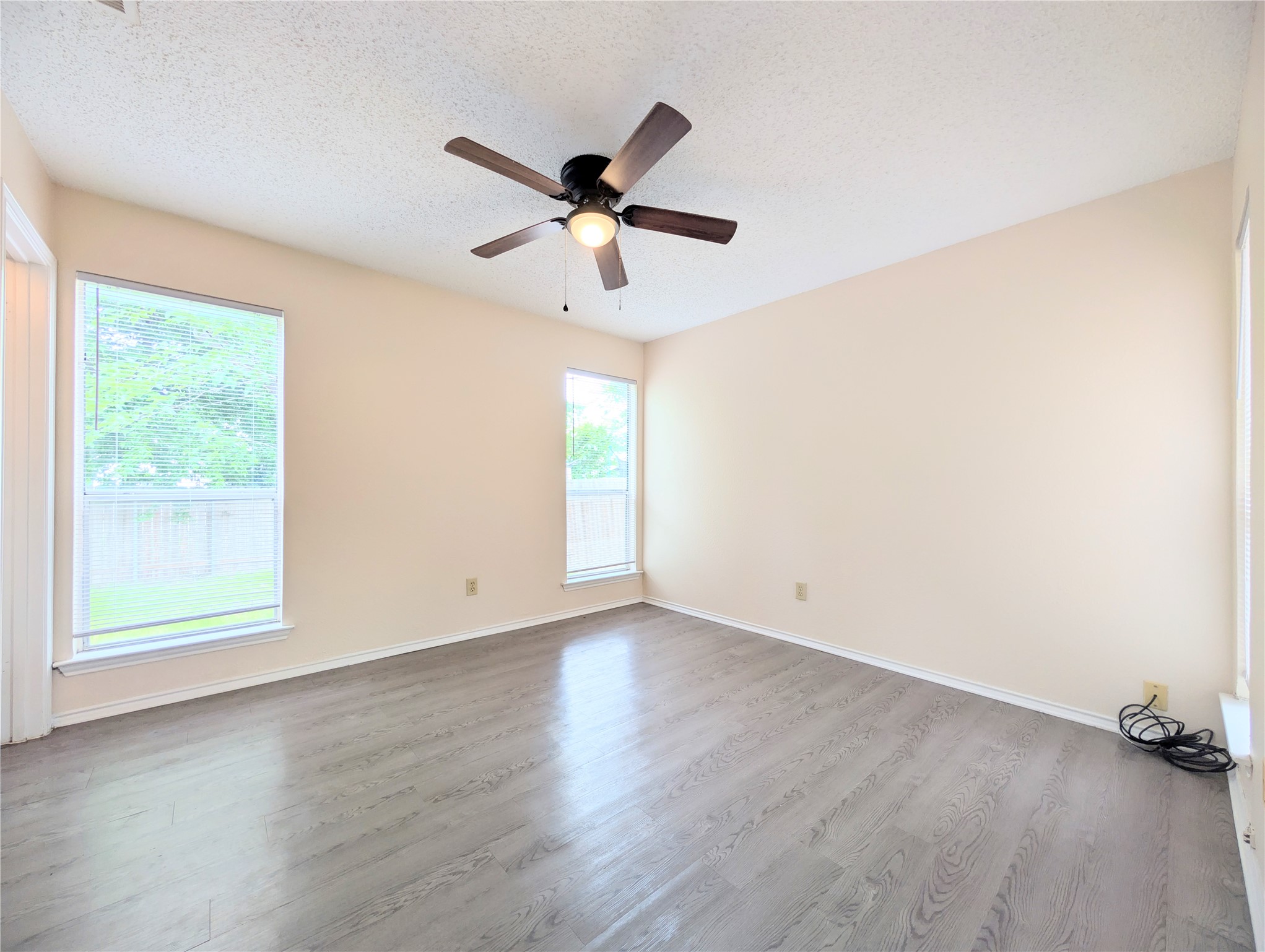 2018 Redwing Way Round Rock, TX 78664 - Photo 19 of 27 Primary bedroom featuring wood-finish flooring, light-toned walls, and a vaulted ceiling