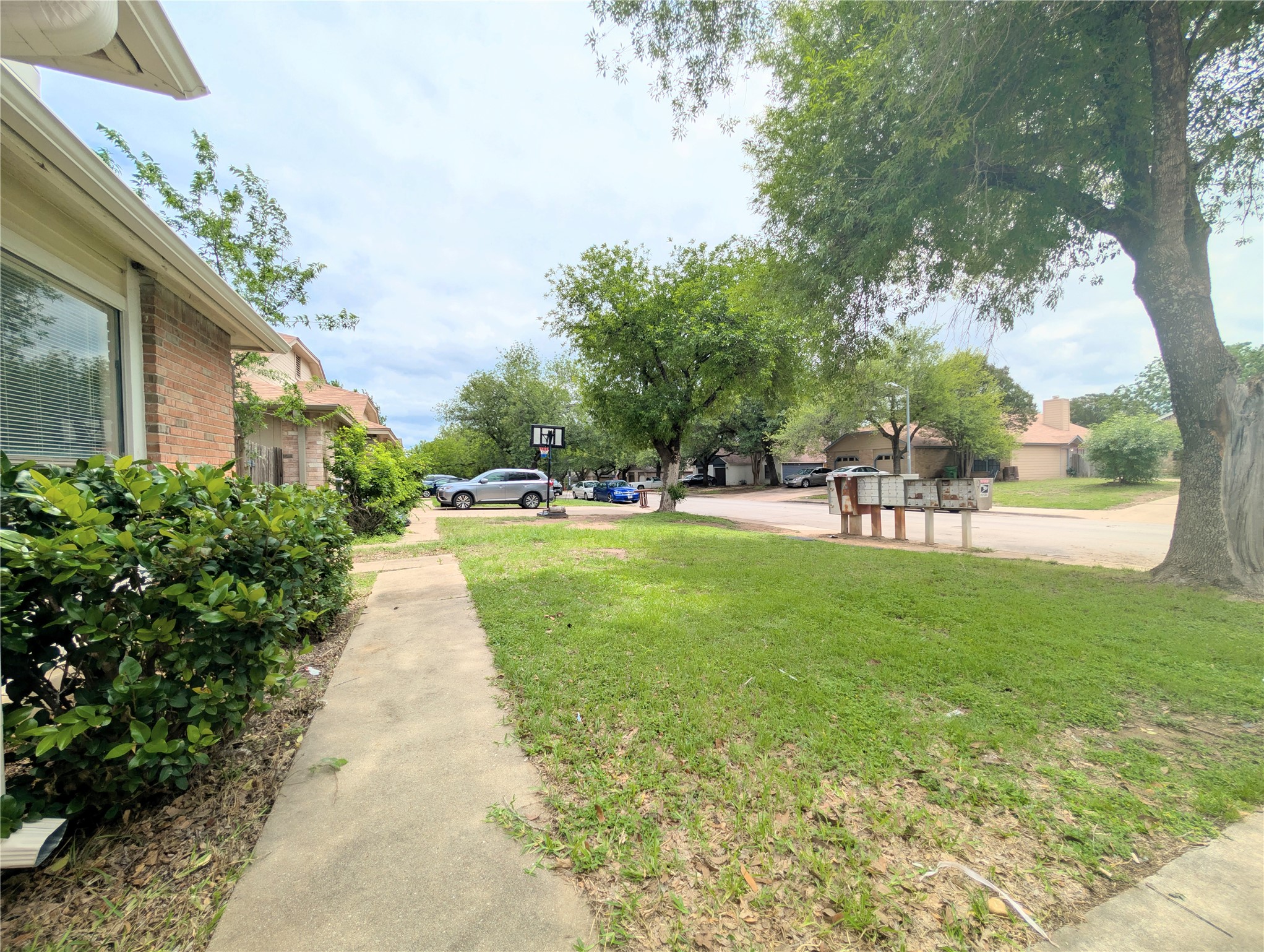 2018 Redwing Way Round Rock, TX 78664 - Photo 3 of 27 Front Yard & entrance sidewalk. Brick facade featuring white trim and a concrete walkway