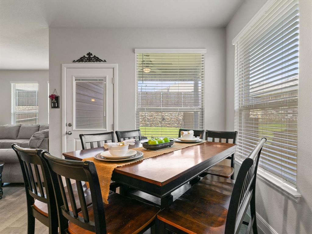 270 Lunayena Road Rhome, TX 76078 - Photo 20 of 37 The dining area offers a welcoming space for everyday meals and special gatherings, with an open flow to the kitchen and living room that creates a functional layout for entertaining and daily living.