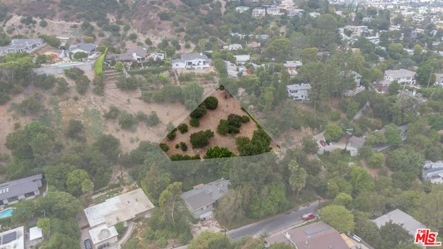an aerial view of a house with a yard and garden