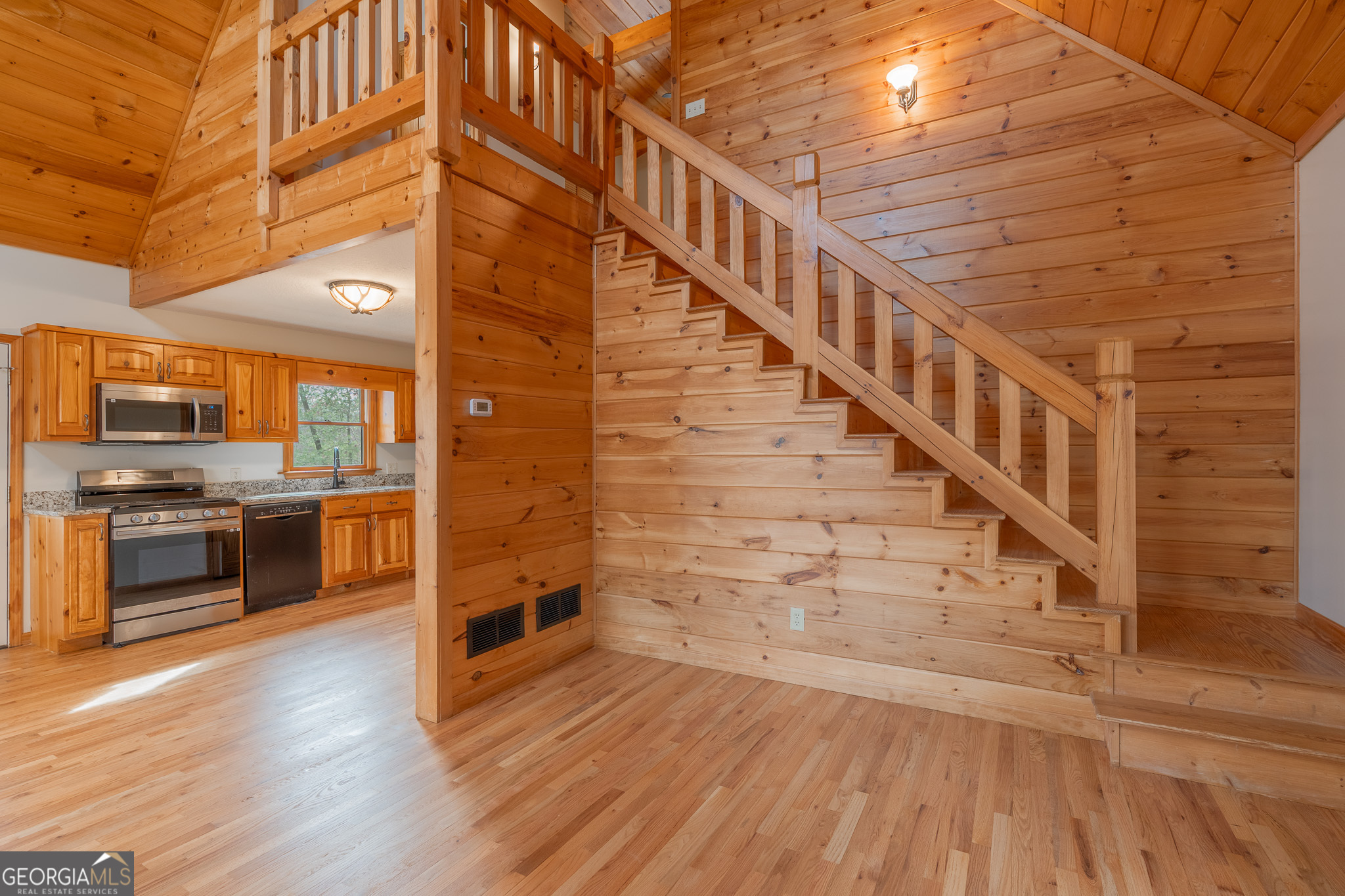 148 Gradient Court Ellijay, GA 30540 - Photo 19 of 28 a view of a hallway with wooden floors and kitchen appliances