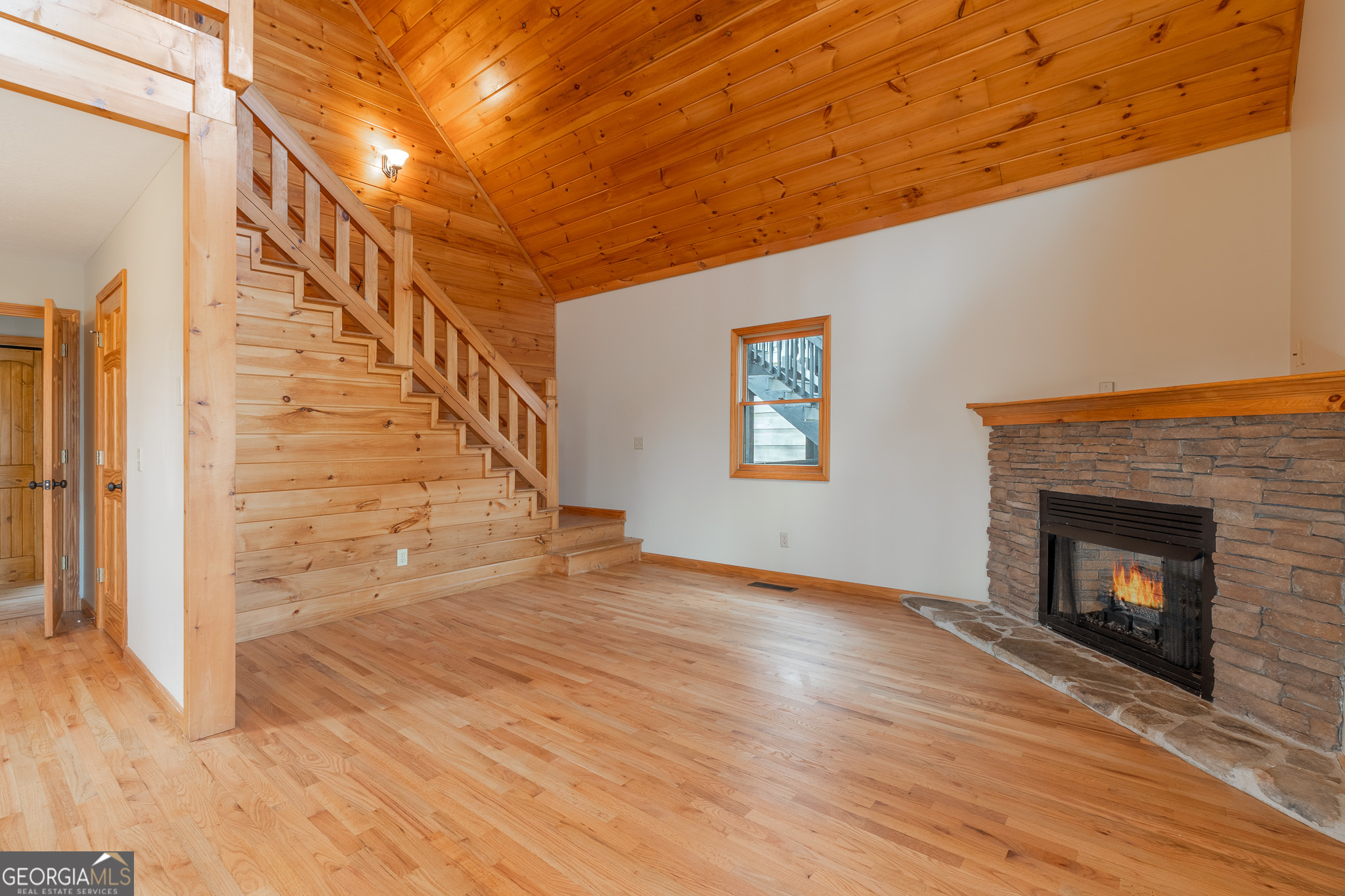 148 Gradient Court Ellijay, GA 30540 - Photo 7 of 28 a view of an empty room with wooden floor and a fireplace