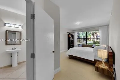 a bed sitting in a bedroom and tv