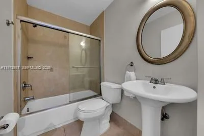 a bathroom with a toilet and shower