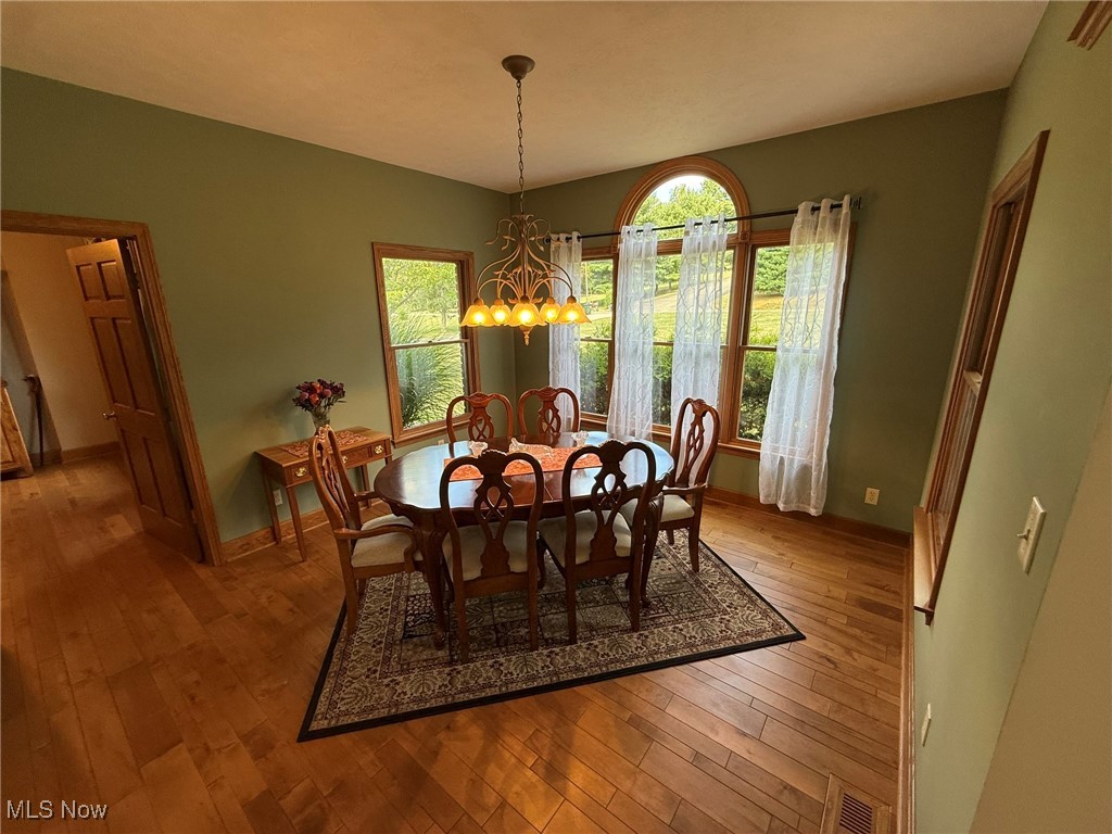2178 Pleasant Valley Road Northeast New Philadelphia, OH 44663 - Photo 17 of 50 Dining room with light wood finished floors and a chandelier