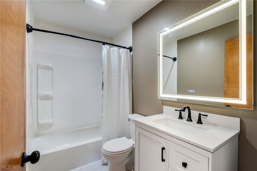3940 Shelby Road Youngstown, OH 44511 - Photo 13 of 20 White vanity with black hardware, integrated sink, and black faucet