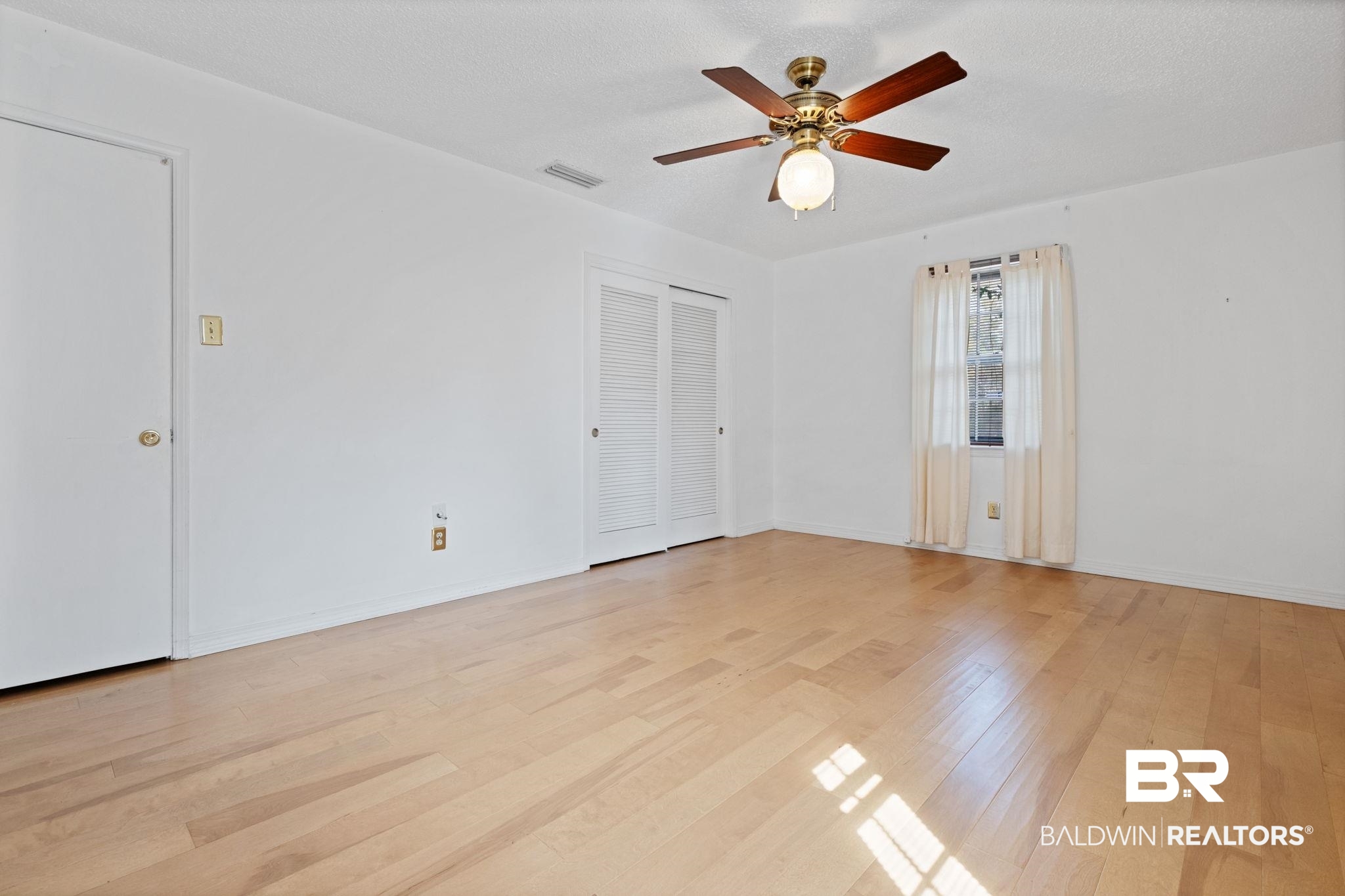 6261 Old Pascagoula Road Theodore, AL 36582 - Photo 26 of 29 Spare room featuring ceiling fan, a textured ceiling, and light wood-type flooring