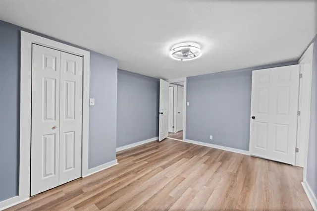 a view of an empty room with wooden floor