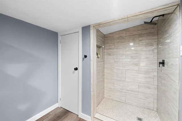 a bathroom with a glass door shower