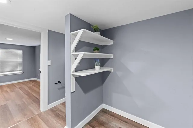 a view of entryway and hall with wooden floor