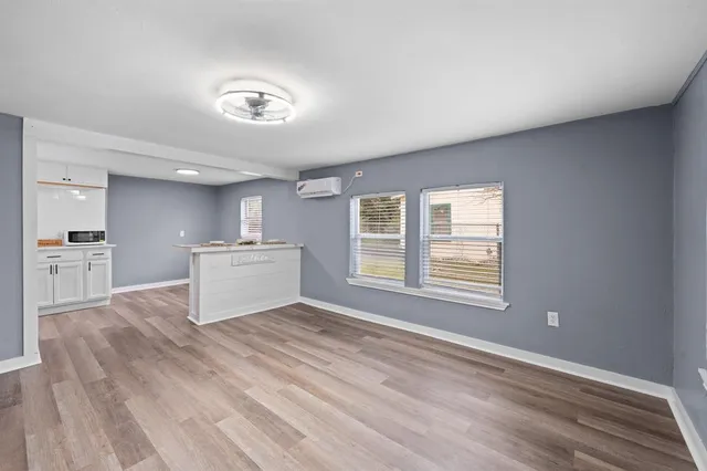 a view of a kitchen with microwave and cabinets
