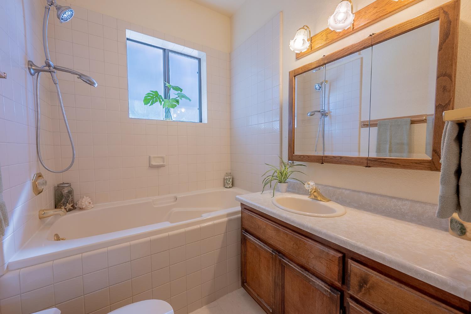 5912 Old Gulch Road San Andreas, CA 95249 - Photo 11 of 71 a bathroom with a granite countertop sink and a bathtub