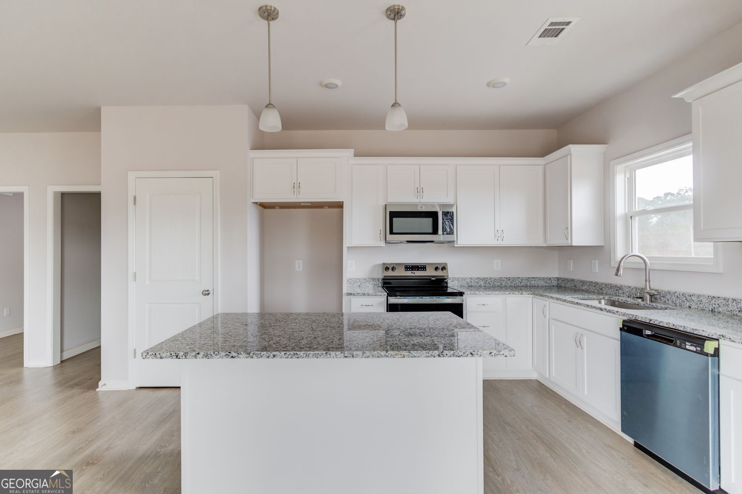 255 Cool Springs Road, Unit ROAD 7 Clarkesville, GA 30523 - Photo 14 of 42 a kitchen with stainless steel appliances granite countertop a sink a stove a refrigerator a center island with wooden floor and cabinets
