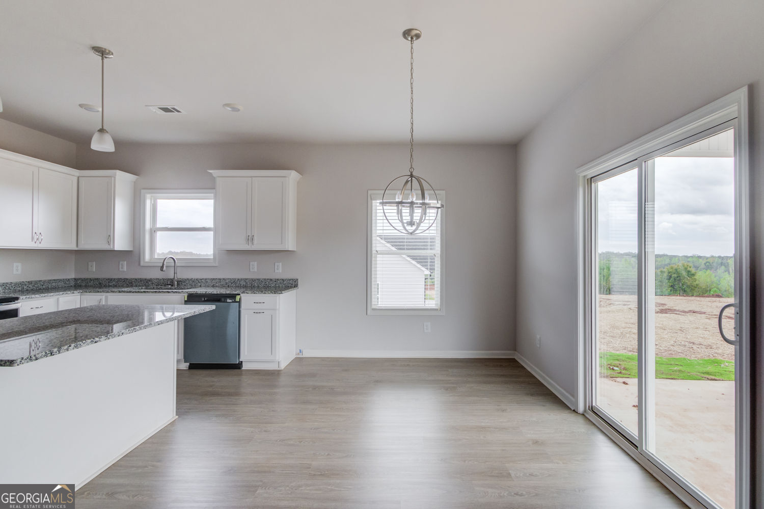 255 Cool Springs Road, Unit ROAD 7 Clarkesville, GA 30523 - Photo 17 of 42 a kitchen with stainless steel appliances granite countertop a stove a sink a center island a refrigerator and a window
