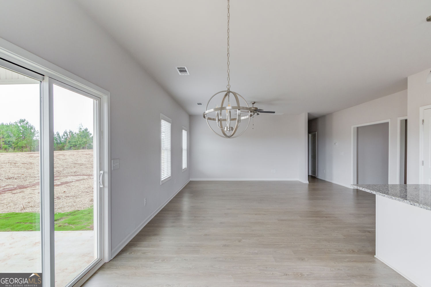 255 Cool Springs Road, Unit ROAD 7 Clarkesville, GA 30523 - Photo 19 of 42 a view of a room with a large window chandelier and wooden floor