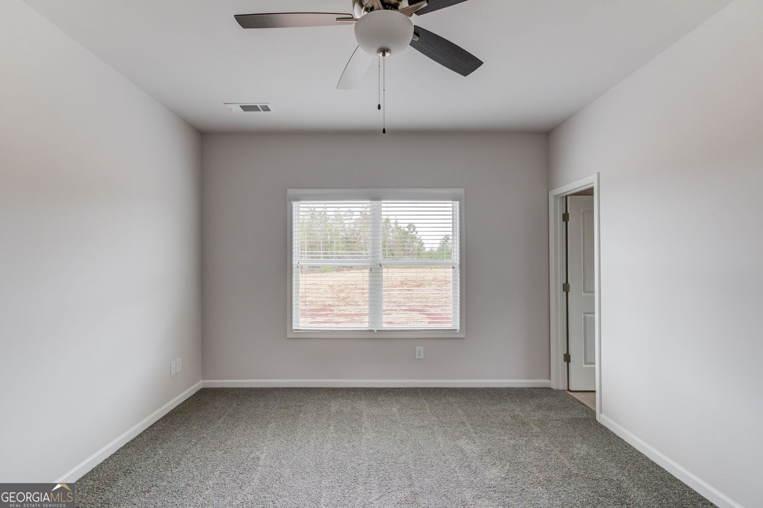 255 Cool Springs Road, Unit ROAD 7 Clarkesville, GA 30523 - Photo 21 of 42 an empty room with a window and a fan