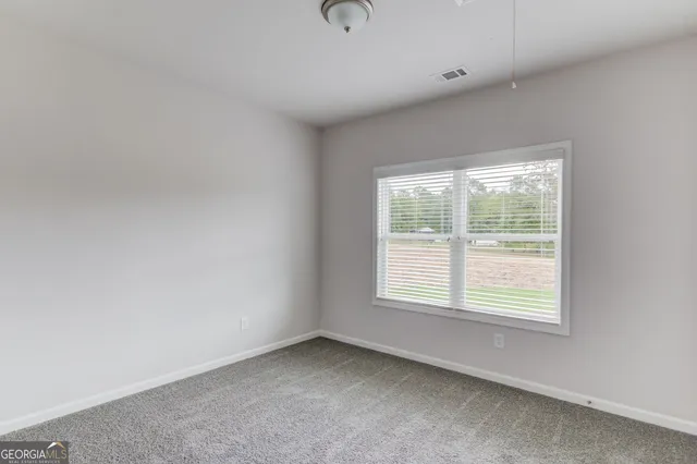 a view of an empty room and a window