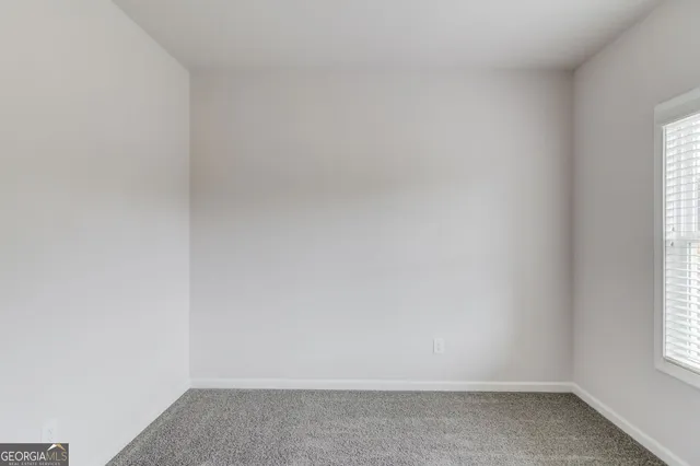 a view of an empty room with windows