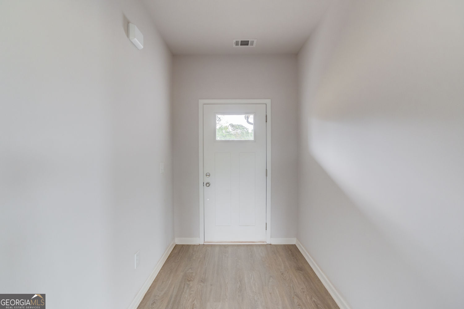 255 Cool Springs Road, Unit ROAD 7 Clarkesville, GA 30523 - Photo 6 of 42 a view of an empty room with wooden floor and a window