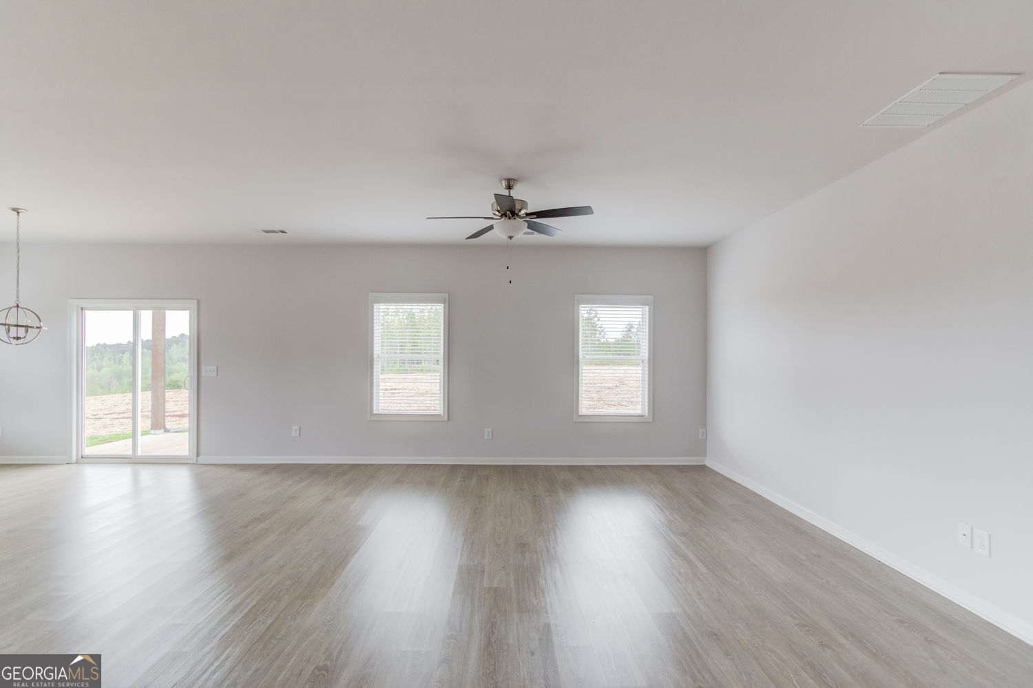 255 Cool Springs Road, Unit ROAD 7 Clarkesville, GA 30523 - Photo 7 of 42 a view of an empty room with wooden floor and a window