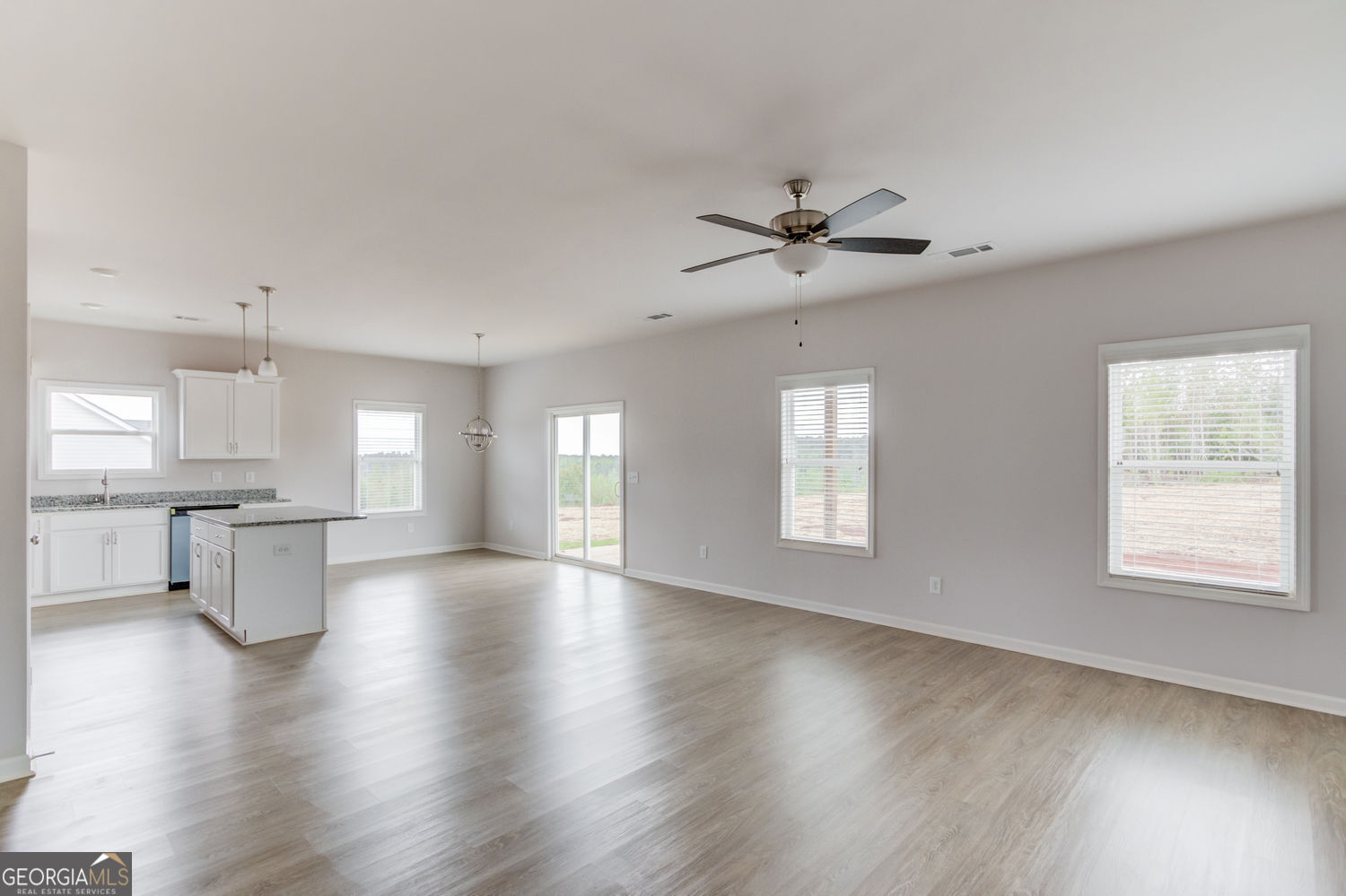 255 Cool Springs Road, Unit ROAD 7 Clarkesville, GA 30523 - Photo 8 of 42 a view of an empty room with a kitchen and wooden floor