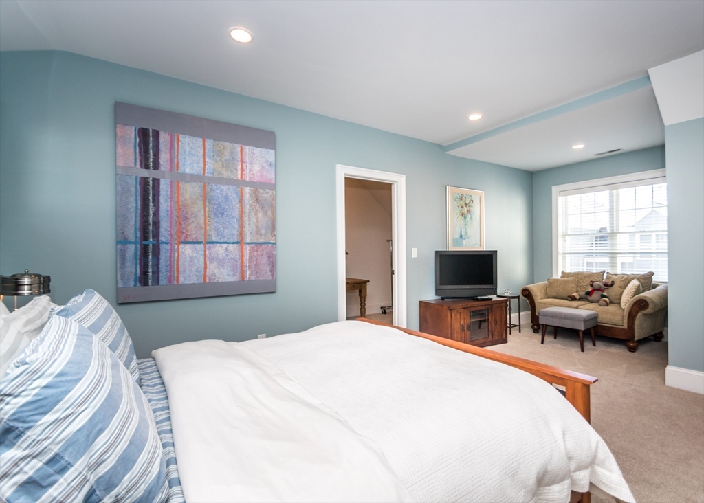 128 Church Street, Unit 2 Waltham, MA 02452 - Photo 23 of 41 a bedroom with a balcony a bed and a couch