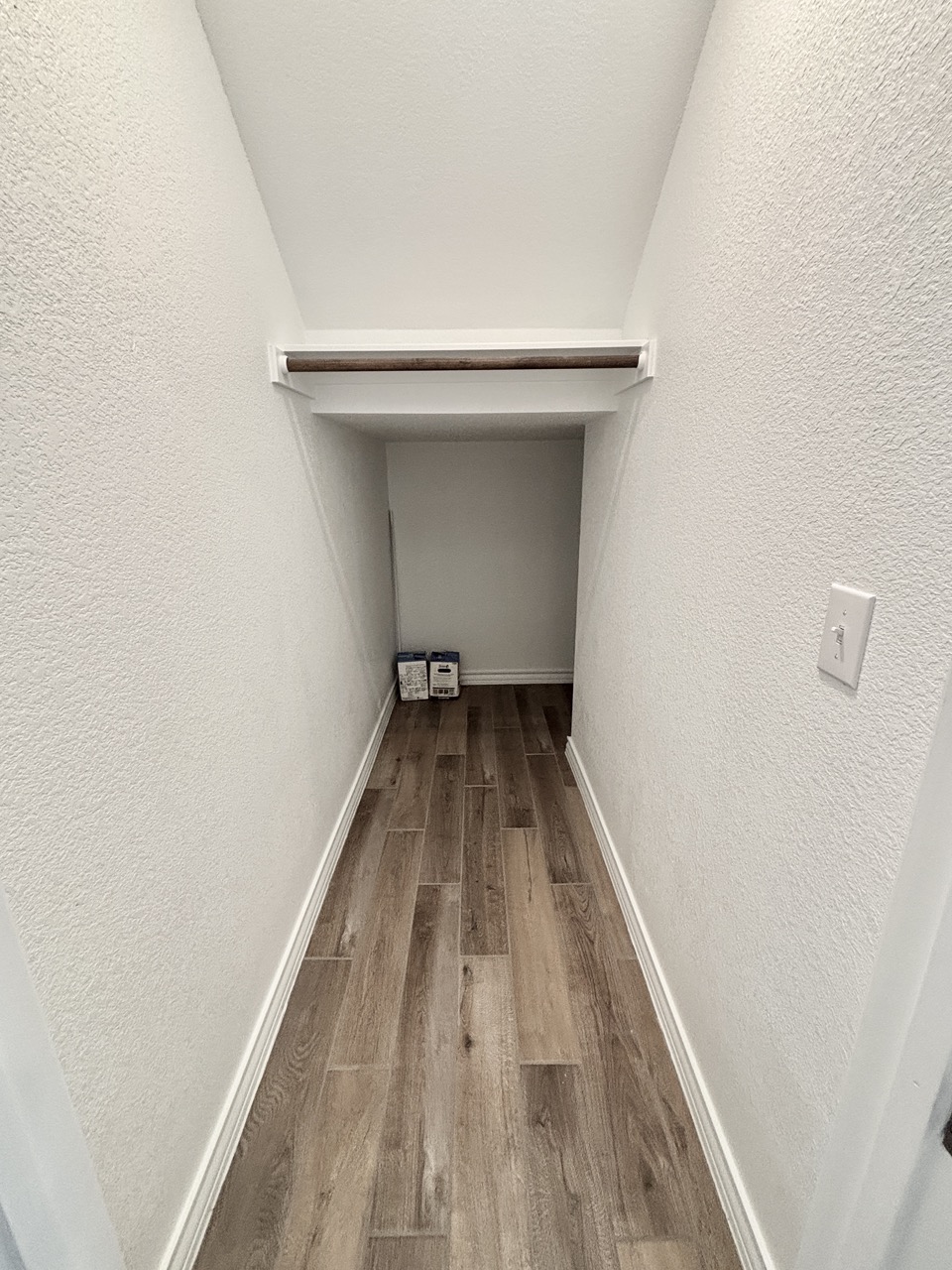 7606 Elk Grove Path Austin, TX 78754 - Photo 11 of 40 Corridor with light wood finished floors and a textured wall