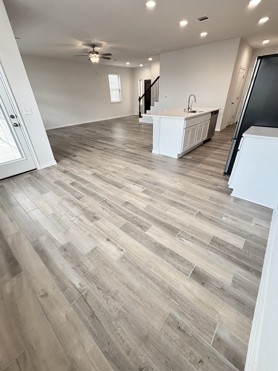 7606 Elk Grove Path Austin, TX 78754 - Photo 40 of 40 Kitchen with open floor plan, recessed lighting, freestanding refrigerator, a center island with sink, and light wood-style flooring