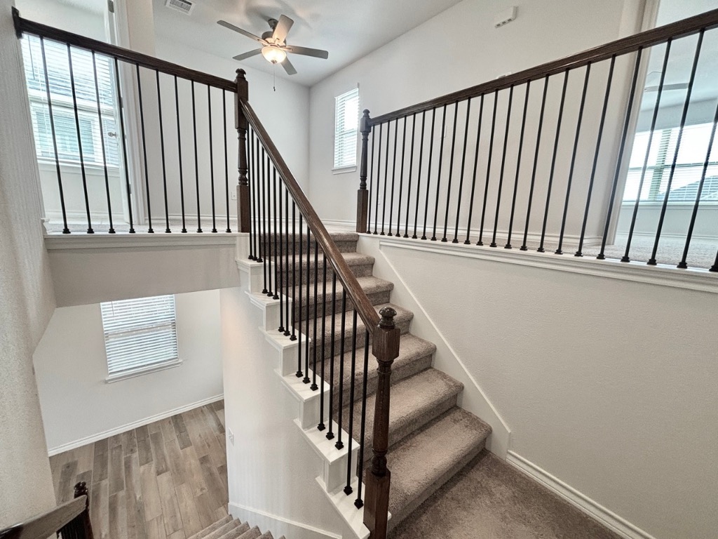 7606 Elk Grove Path Austin, TX 78653 - Photo 16 of 40 Stairs featuring wood finished floors and a ceiling fan