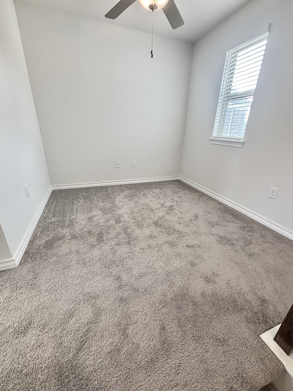7606 Elk Grove Path Austin, TX 78754 - Photo 17 of 40 Empty room with light colored carpet and baseboards