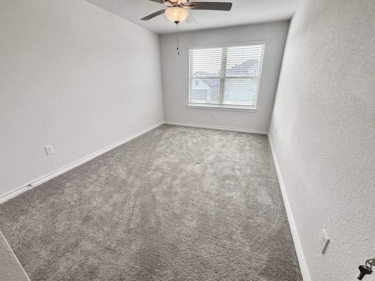 7606 Elk Grove Path Austin, TX 78754 - Photo 24 of 40 Carpeted empty room with a textured wall and ceiling fan