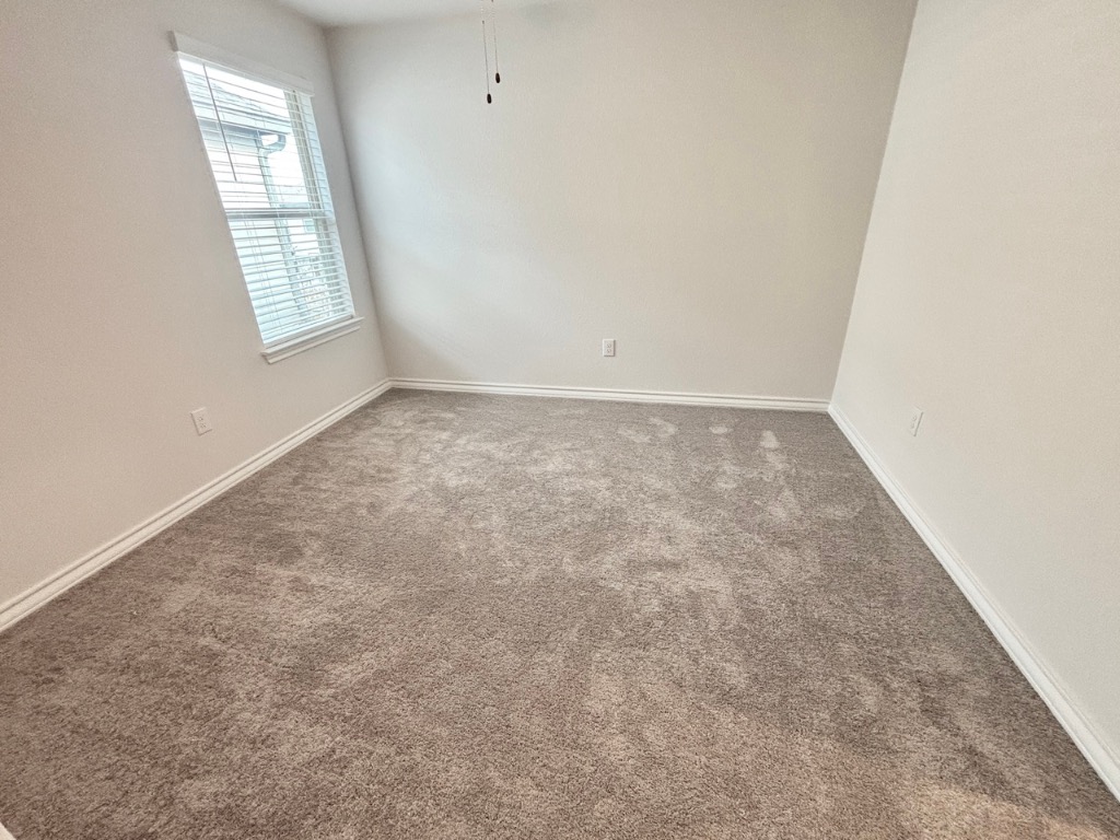 7606 Elk Grove Path Austin, TX 78653 - Photo 27 of 40 Unfurnished room with carpet floors and baseboards