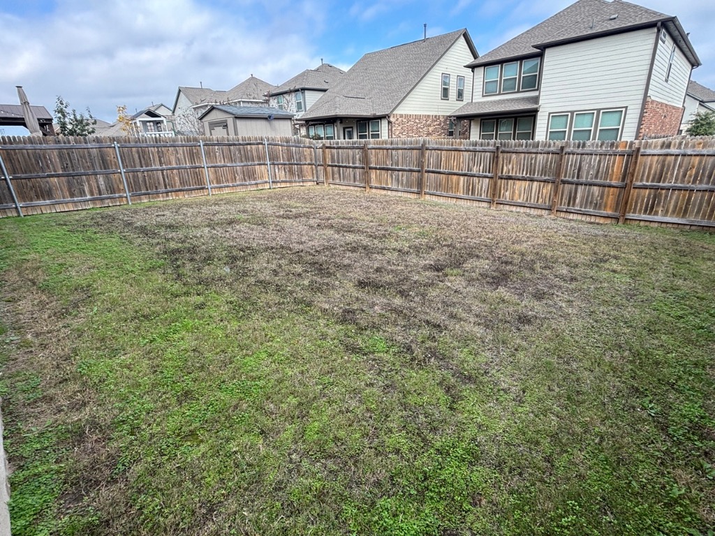 7606 Elk Grove Path Austin, TX 78653 - Photo 31 of 40 Fenced backyard with a residential view
